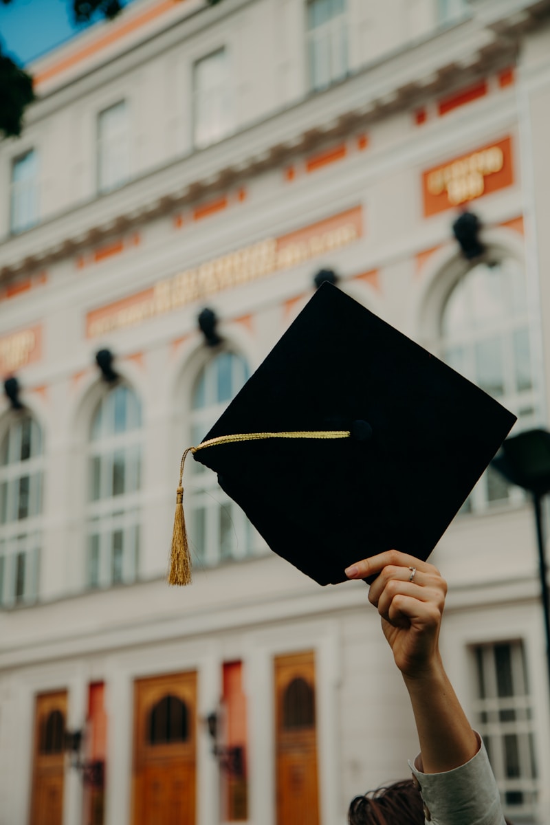 Photo by RUT MIIT person holding black academic hat